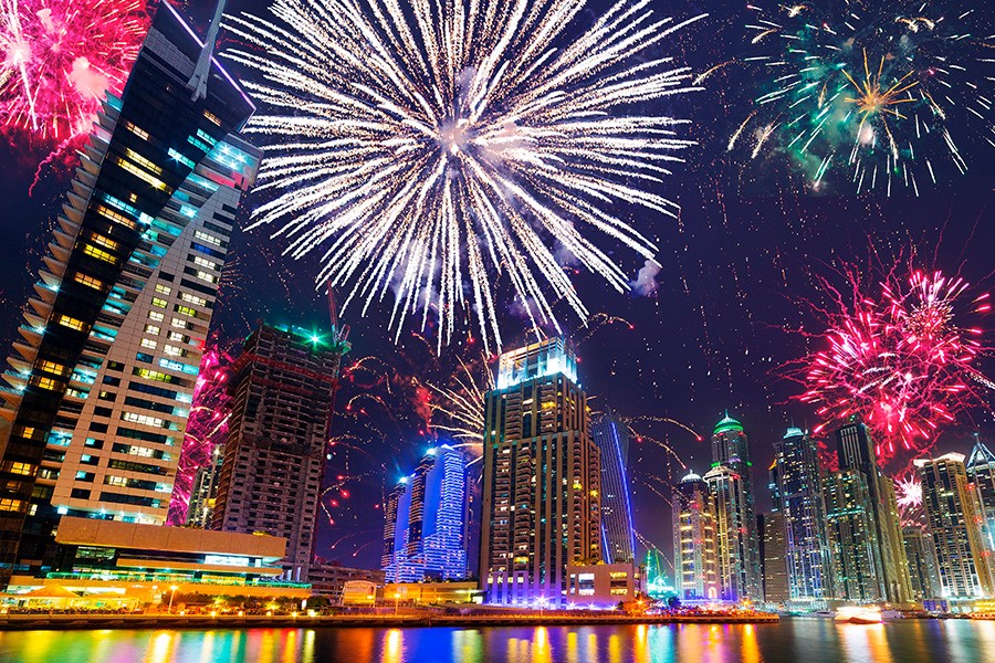 Colorful fireworks illuminate the Dubai skyline, featuring Burj Khalifa, in celebration of Dubai National Day