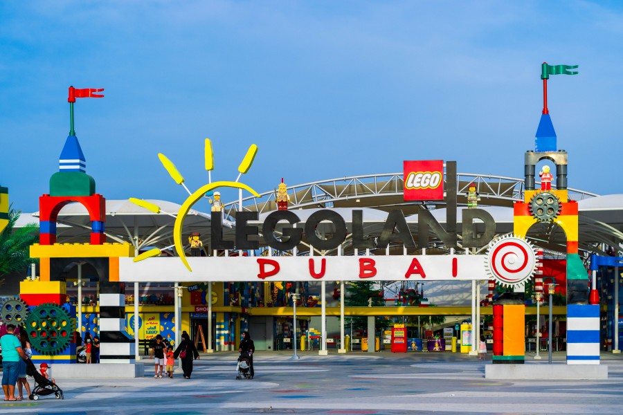 Visitors enjoy the lively atmosphere at Legoland Dubai's entrance, perfect for family fun in Dubai Parks and Resorts