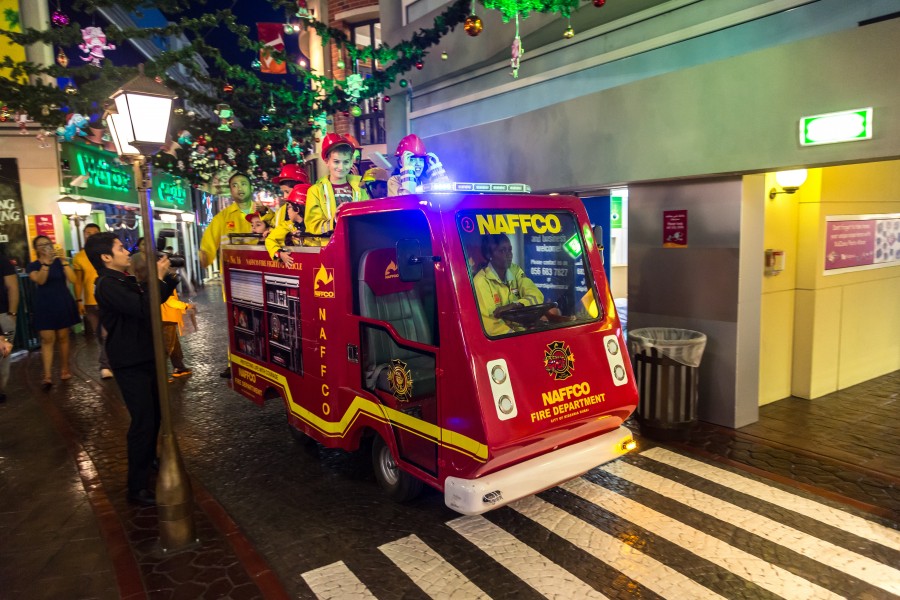 A bright red fire truck sits in the street, sparking excitement for kids visiting KidZania in Dubai Mall