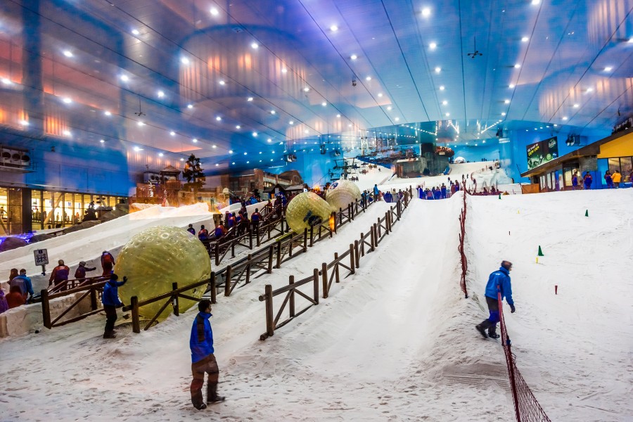 A group of people skiing down an indoor slope at Ski Dubai, showcasing a fun activity for families