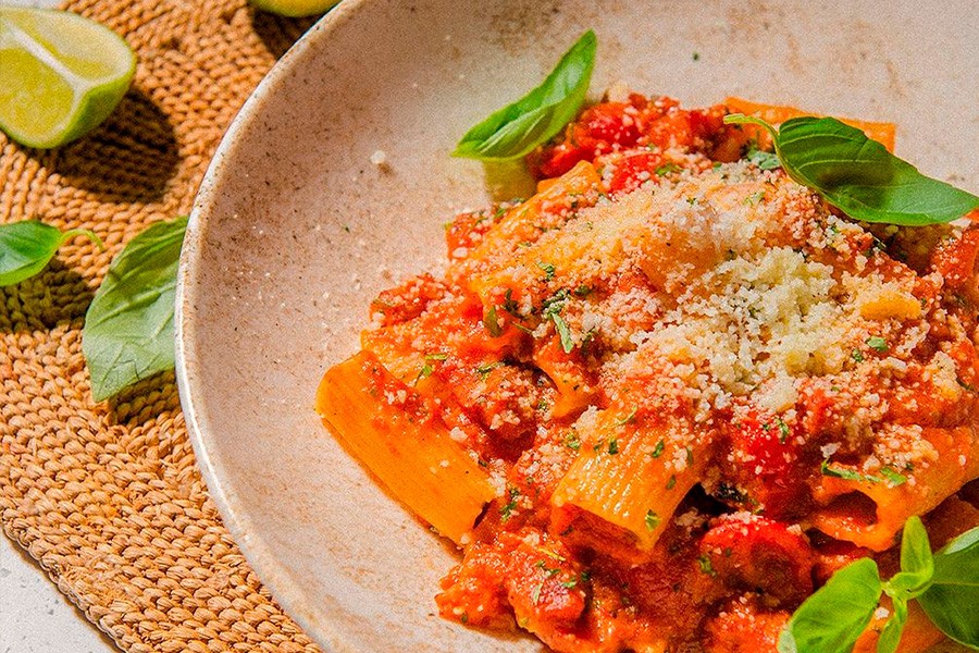 A delicious plate of bolognese pasta topped with rich tomato sauce, perfect for kids at family-friendly restaurants in Dubai