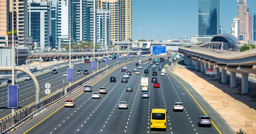 A bustling highway scene in Dubai with cars navigating through the city's impressive skyline