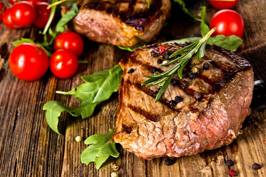 Grilled beef steak garnished with cherry tomatoes and herbs, enjoyed during a holiday in Siena, Italy.