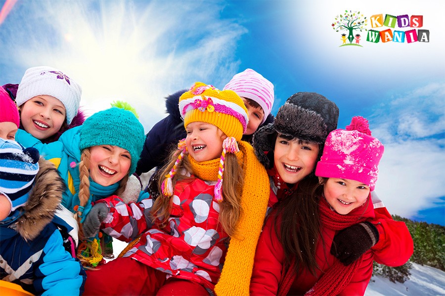 A group of children poses for a photo at the Abu Dhabi Winter Camps, smiling and enjoying their time together