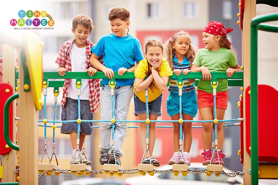 Kids engaging in fun activities on playground equipment during the Top Abu Dhabi Winter Camps 2025–2026