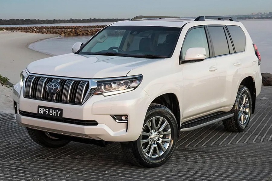 A white 2019 Toyota Land Cruiser parked on a beach, featured in the Best Cars for Families in the UAE.