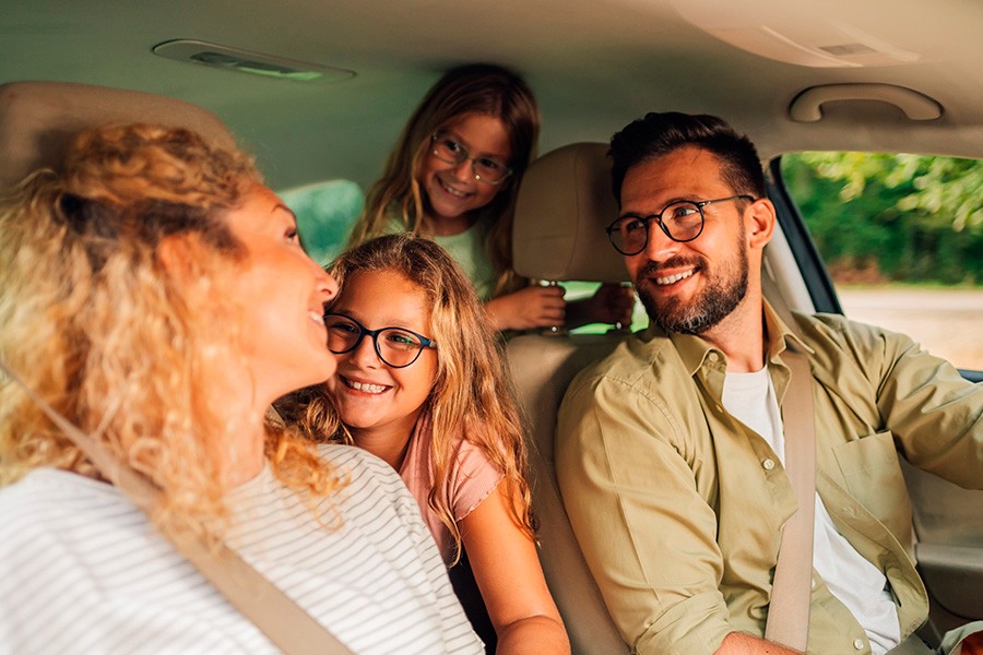 A family of four sits together in the a car, enjoying a ride, highlighting family-friendly vehicles in the UAE